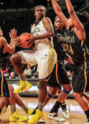 Yellow Jackets F Holston is surrounded by Eagles defenders in the lane