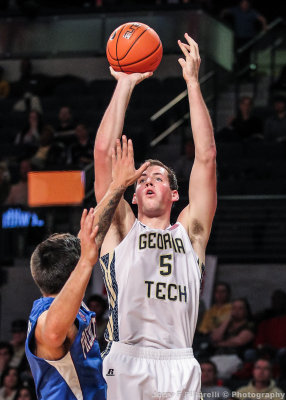 Jackets C Miller puts up a short jumper over a Blue Hose defender