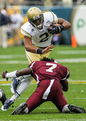 …Jackets QB Lee goes up and over Bulldogs DB Lawrence Barnett