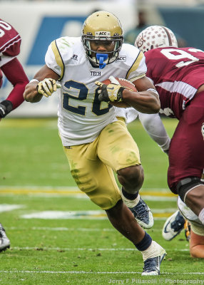 Yellow Jackets BB Sims runs through a hole in the line