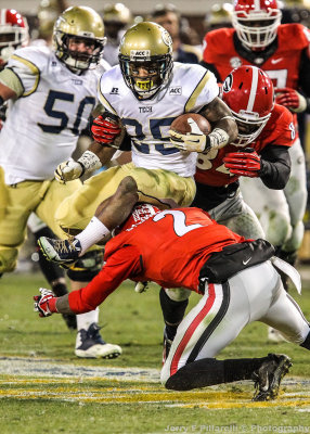 Jackets AB Robert Godhigh hurdles Bulldogs CB Sheldon Dawson in the open field