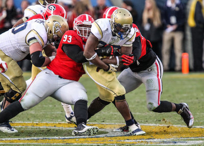 Georgia Tech BB David Sims is tackled by Georgia N Chris Mayes