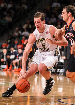 Georgia Tech C Miller dribbles at the three point line defended by Illinois C Maverick Morgan