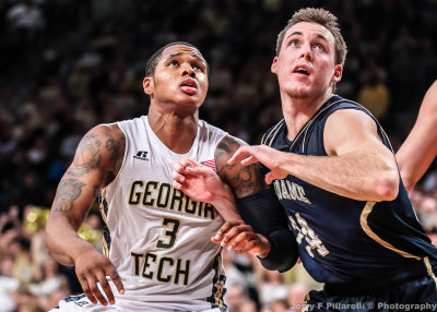 Tech G Marcus Georges-Hunt and Fighting Irish F Connaughton fight for rebounding position