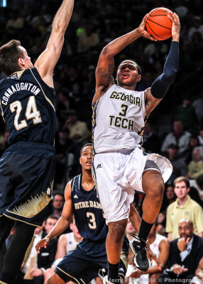 Yellow Jackets F Georges-Hunt drives and shoots around Irish F Connaughton
