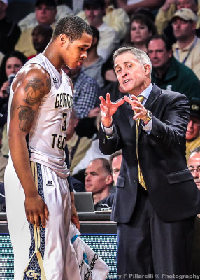 Georgia Tech Yellow Jackets Head Coach Brian Gregory works with F Georges-Hunt as he comes to the bench