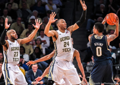 Yellow Jackets F Holsey and G Golden get their hands up as Irish G Atkins looks to pass