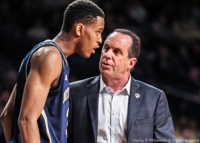 Notre Dame Fighting Irish Head Coach Mike Brey instructs one of his players during a timeout