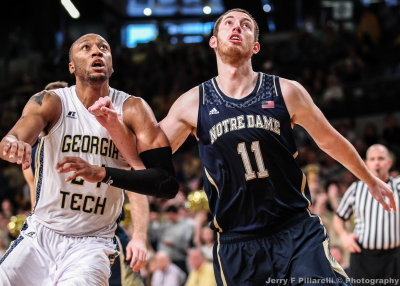 Jackets F Holsey and Fighting Irish C Sherman work for rebounding position