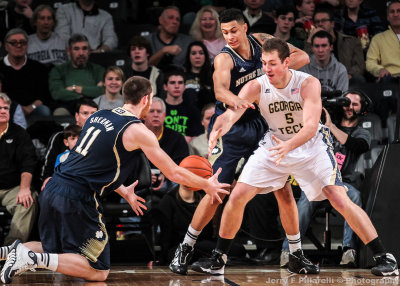 Jackets C Miller fights for the loose ball with Irish C Sherman