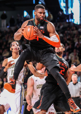 Miami F Raphael Akpejoiri pulls down and secures a rebound