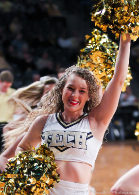 Yellow Jackets Cheerleader runs off the court after a timeout