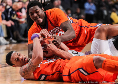 Tigers F KJ McDaniels and F Josh Smith wrestle for a loose ball with a Jackets player