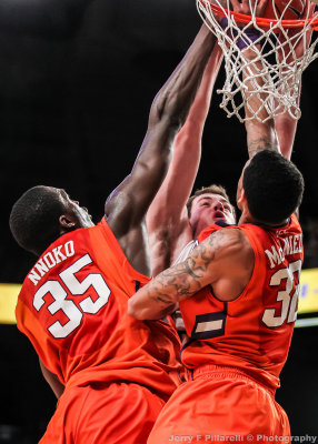 Yellow Jackets C Miller goes up strong against Tigers C Nnoko and F McDaniels