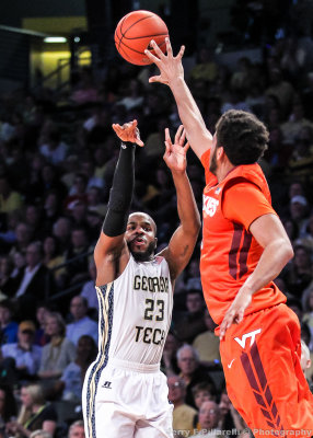 Georgia Tech G Trae Golden shoots the three under pressure from a Virginia Tech player