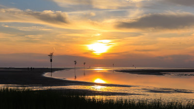 The sun setting at low tide over Rock Harbor on Cape Cod