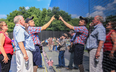 Visitors locate names on the Vietnam Veterans Memorial in Washington DC