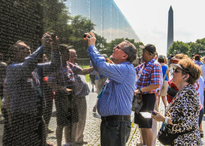 Visitors locate names on the Vietnam Veterans Memorial in Washington DC