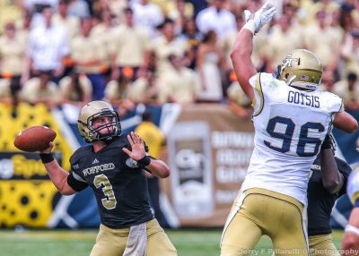 Wofford QB Jacks throws over the outstretched arm of Tech DL Adam Gotsis
