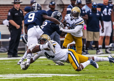 Yellow Jackets DB Jamal Golden dives to tackle Eagles WR Zach Walker