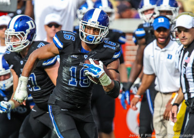 Blue Devils S Jeremy Cash runs down the sidelines with an interception
