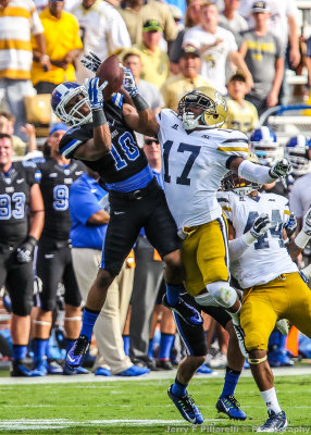 Duke WR Ryan Smith wrestles for an onside kick with Jackets DB Lance Austin