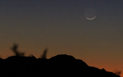 The moon shortly after sunset with Kitt Peak Observatory in the foreground