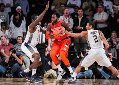 Yellow Jackets G Chris Bolden tries to poke the ball away from Cuse F Rakeem Christmas