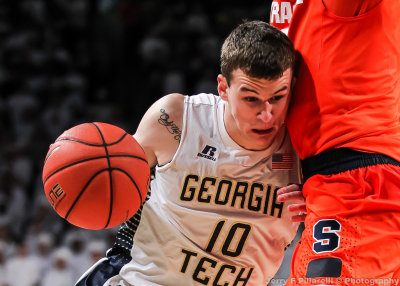 Yellow Jackets G Travis Jorgenson leans in to get past an Orange defender