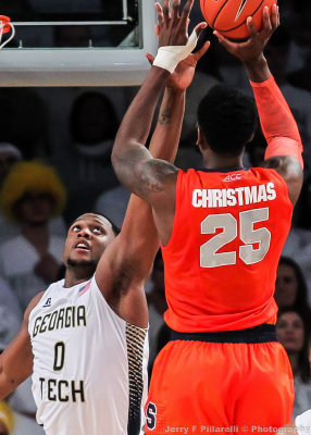 Jackets F Mitchell looks to disrupt a shot by Orange F Christmas