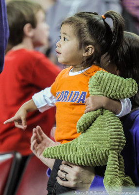 Florida Gators Fan and her Gator watch the action