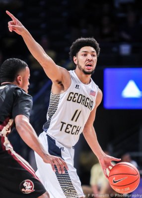 Yellow Jackets G Heath signals his teammates from the point
