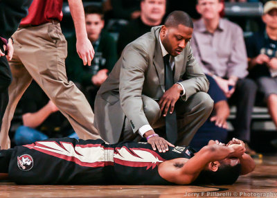 FSU G Devon Bookert is attended to after taking a fall on the court