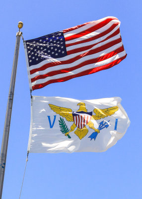 The US and Virgin Island flags fly in Virgin Islands National Park