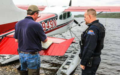 Kevin (note the mosquitos) discusses our route with a North Slope Borough Police officer in Gates of the Arctic National Park