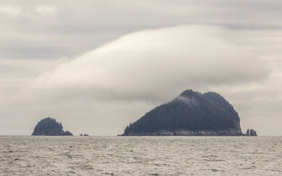 An island with its own cloud formation in Kenai Fjords National Park