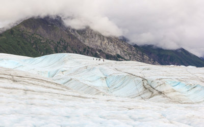 Hikers in the distance on Root Glacier in Wrangell-St Elias National Park