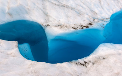 A blue pool in a crevasse on Root Glacier in Wrangell-St Elias National Park