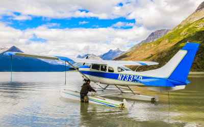 Pilot Glen Alsworth secures the floatplane on Kenibuna Lake near Shamrock Glacier in Alaska