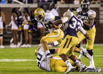 Georgia Tech QB Byerly leaps over a downed lineman to avoid Alcorn St. LB Watkins