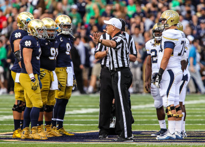 Fighting Irish and Yellow Jackets meet at midfield for the coin toss