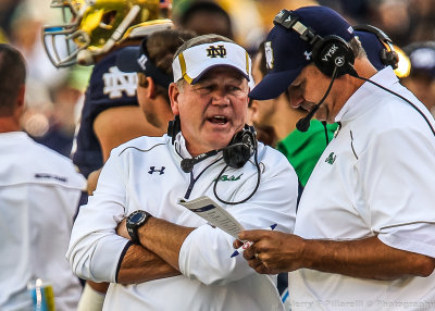 Notre Dame Fighting Irish Head Coach Brian Kelly talks with one of his coaches