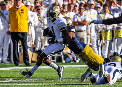 Yellow Jackets A-back Qua Searcy is corralled by a Fighting Irish defender