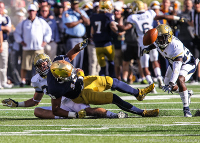 Irish TE Alize Jones loses the ball after being wrapped up by Jackets LB Marcordes