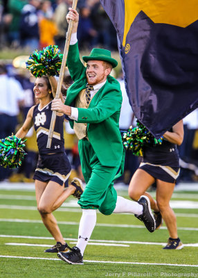 Fighting Irish Mascot The Leprechaun carries the flag after a score