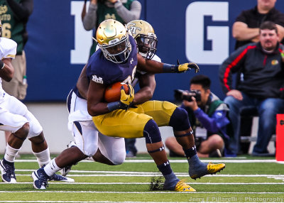 Fighting Irish RB Prosise is spun around and tackled by a Jackets defender