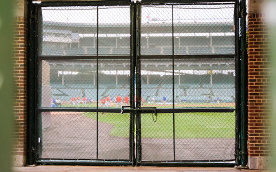 Looking into Wrigley Field through the fence on Sheffield Avenue
