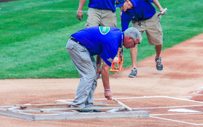The Wrigley Field grounds crew prepares home plate prior to the game