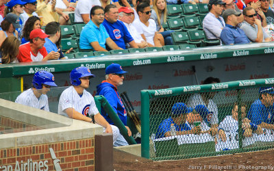 Cubs Manager Joe Maddon watches the game from the dugout