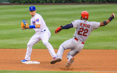 Cubs SS Javier Baez makes the turn as the Cards Jason Heyward approaches